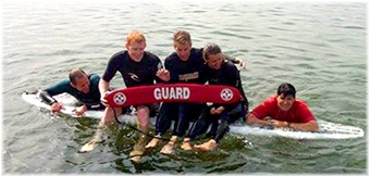 Lifeguards - on surfboards in group photo